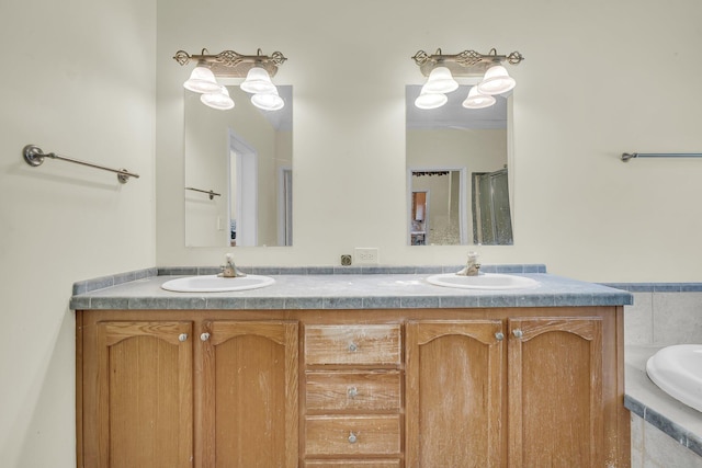 bathroom featuring a relaxing tiled tub and vanity