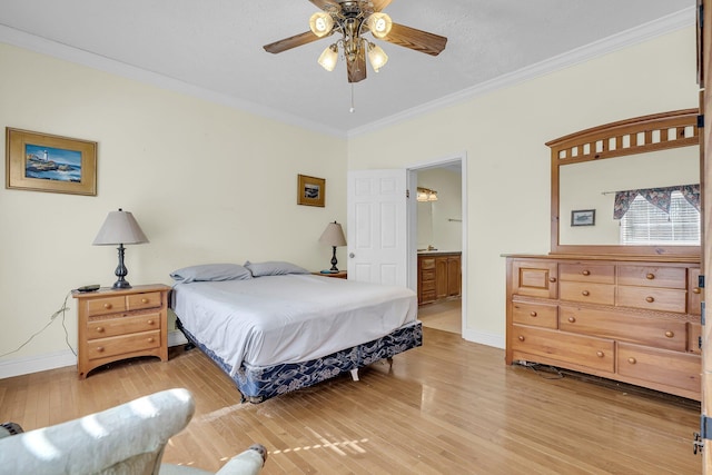 bedroom featuring crown molding, light hardwood / wood-style flooring, ceiling fan, and ensuite bathroom