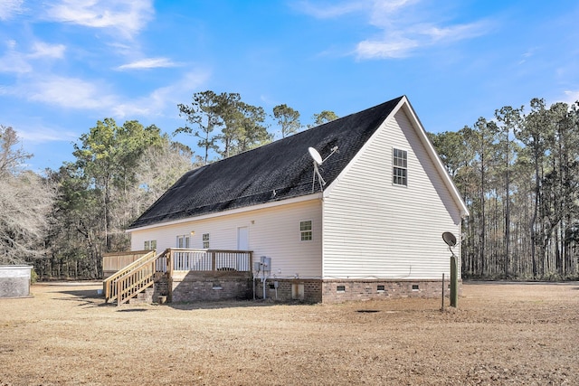 view of property exterior featuring a wooden deck and a yard