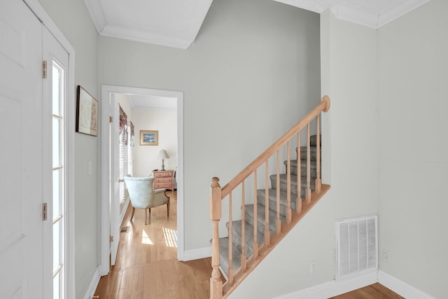 entryway with crown molding and hardwood / wood-style floors