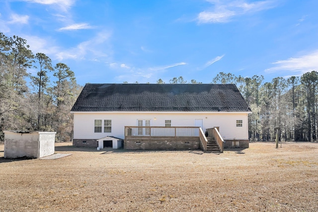 rear view of property with a yard and a deck