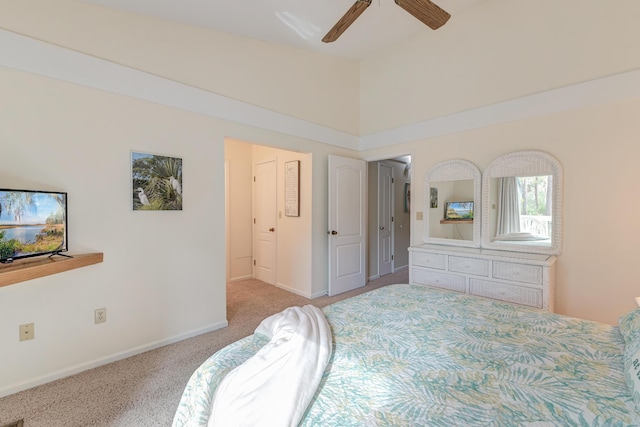 carpeted bedroom with lofted ceiling, baseboards, and ceiling fan