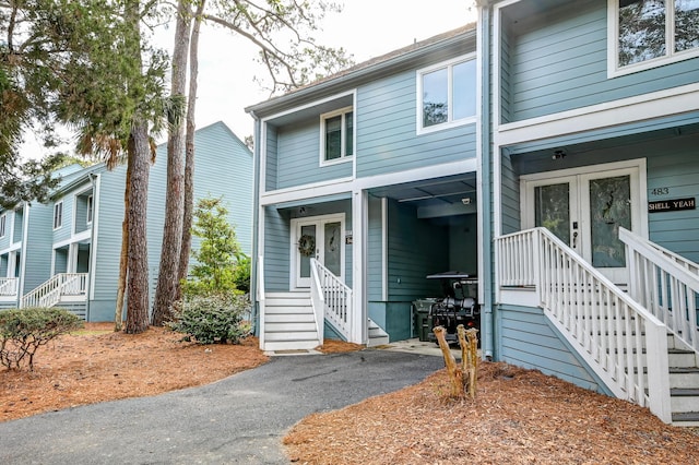 view of front of property featuring french doors and aphalt driveway