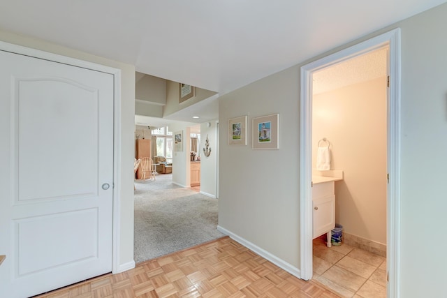 hallway featuring visible vents and baseboards