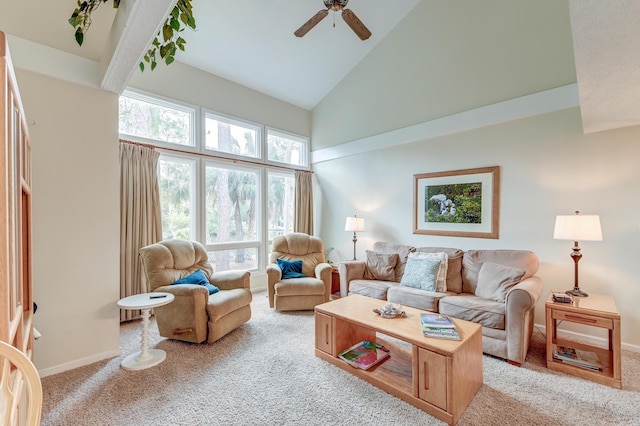 living area featuring baseboards, light colored carpet, ceiling fan, and high vaulted ceiling