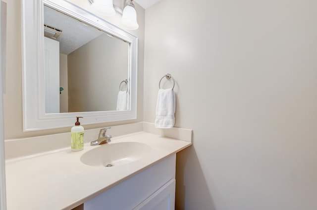 bathroom featuring a textured ceiling and vanity