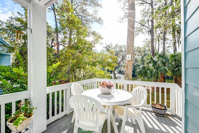 wooden terrace with outdoor dining space