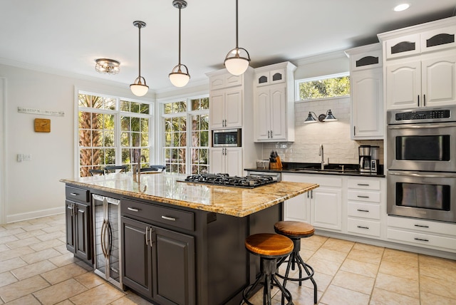 kitchen with white cabinets, tasteful backsplash, beverage cooler, decorative light fixtures, and stainless steel appliances