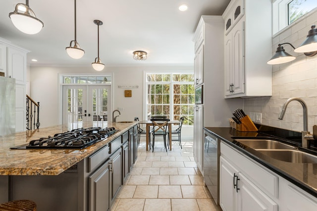 kitchen featuring backsplash, white cabinetry, and sink