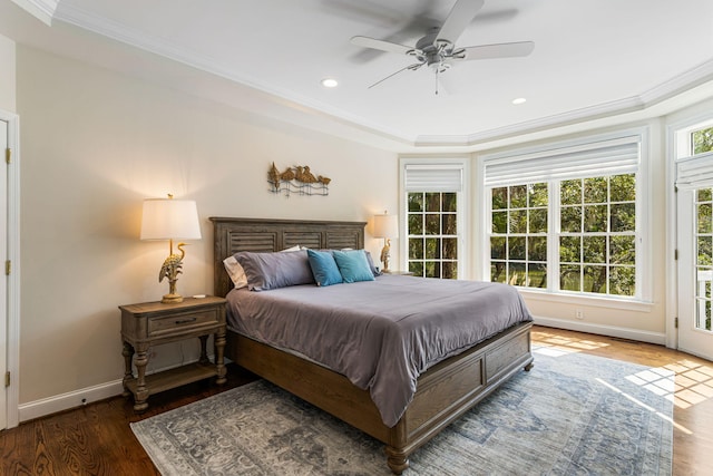 bedroom with crown molding, dark hardwood / wood-style flooring, and ceiling fan