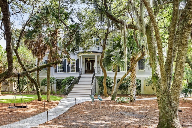 view of front of house featuring a balcony