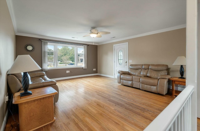 living room featuring crown molding, ceiling fan, and light wood-type flooring