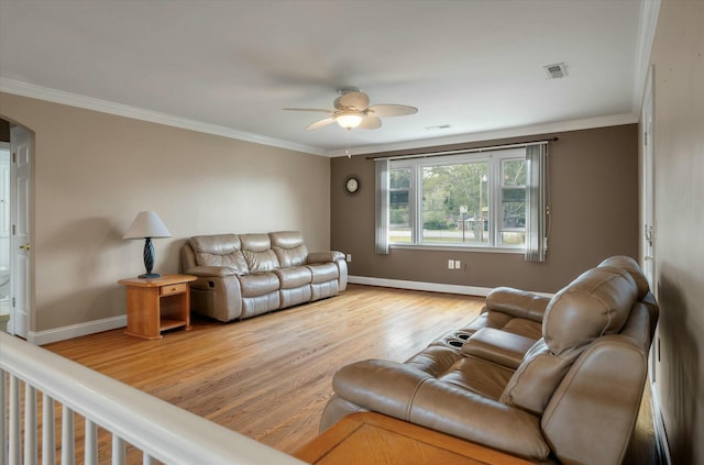 living room featuring light hardwood / wood-style flooring, ceiling fan, and ornamental molding