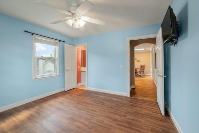 unfurnished bedroom with hardwood / wood-style flooring and ceiling fan