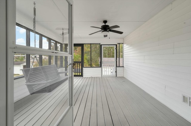 unfurnished sunroom with a wealth of natural light and ceiling fan