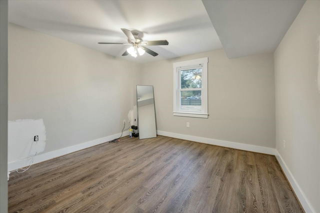 spare room featuring hardwood / wood-style flooring and ceiling fan