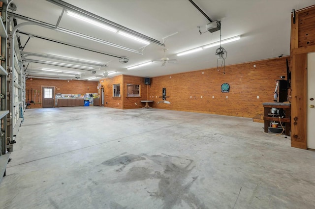 garage with ceiling fan and a garage door opener