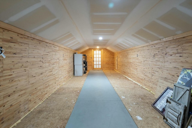 interior space featuring wooden walls and lofted ceiling