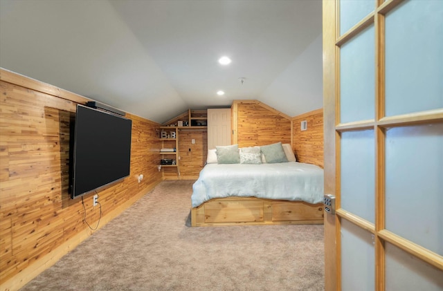 unfurnished bedroom featuring wood walls, carpet floors, and lofted ceiling