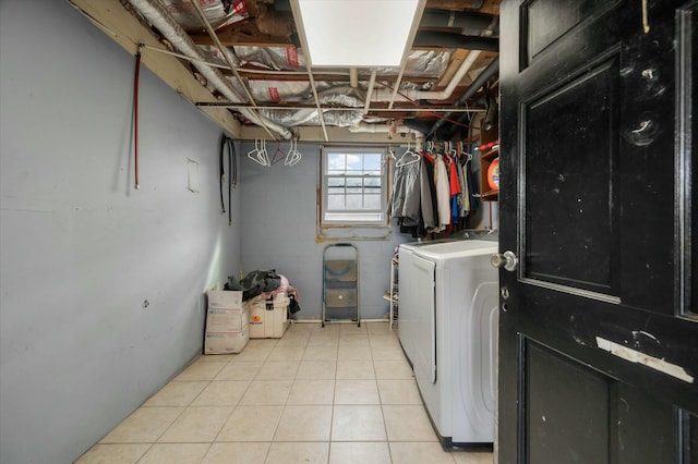 clothes washing area with light tile patterned floors and separate washer and dryer