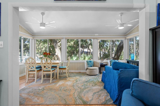 sunroom / solarium with ceiling fan, a wealth of natural light, and vaulted ceiling