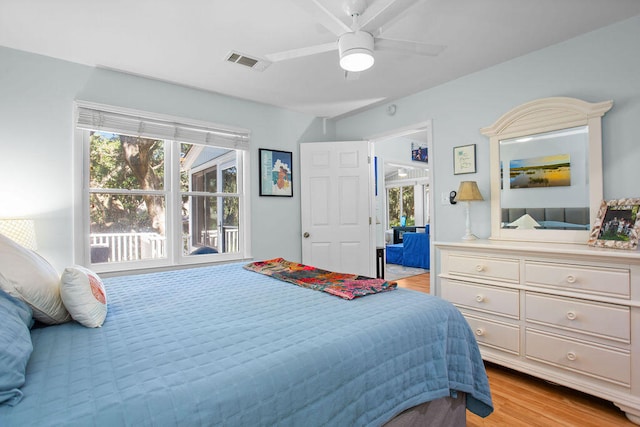 bedroom with light hardwood / wood-style floors and ceiling fan