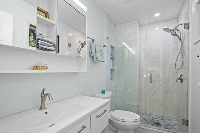 bathroom with vanity, walk in shower, and toilet