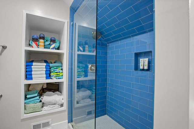 bathroom with a tile shower