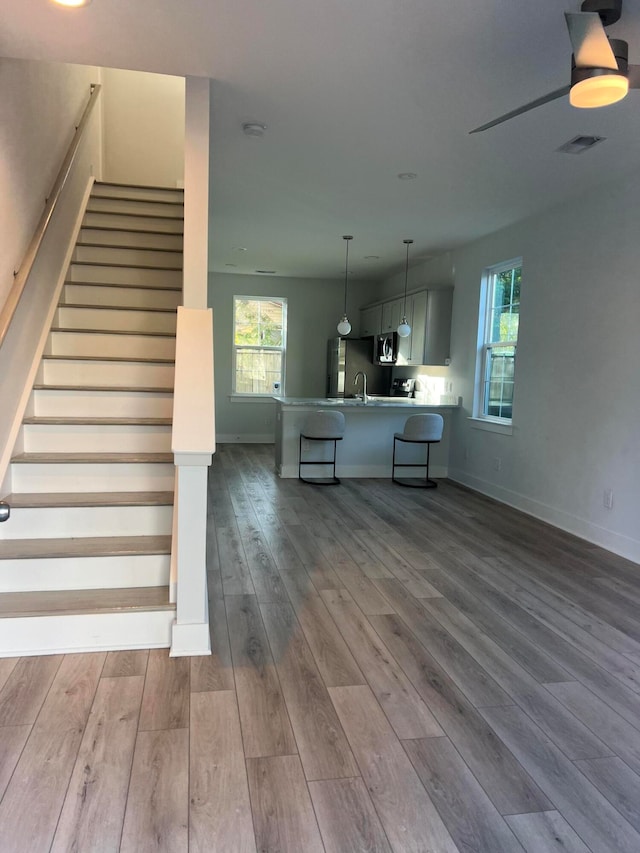 stairway with wood-type flooring and sink