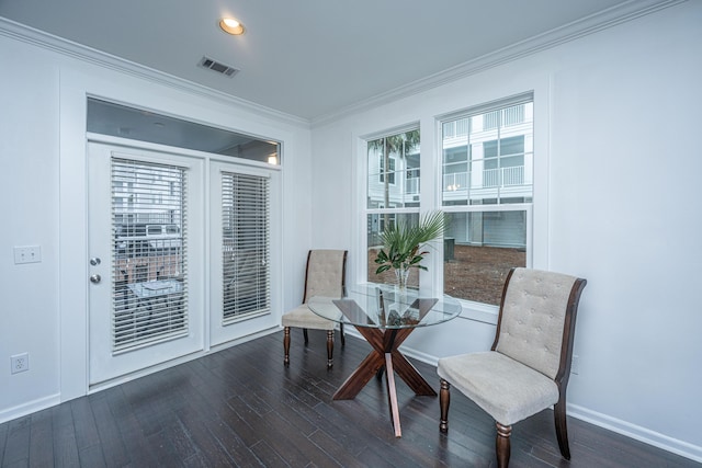 dining room featuring crown molding and dark hardwood / wood-style floors