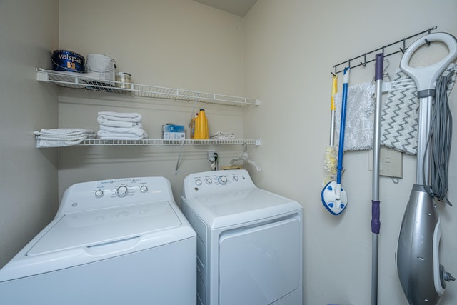 clothes washing area featuring washer and clothes dryer