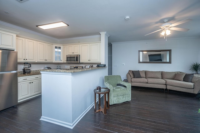 kitchen featuring crown molding, dark hardwood / wood-style flooring, kitchen peninsula, stainless steel appliances, and white cabinets