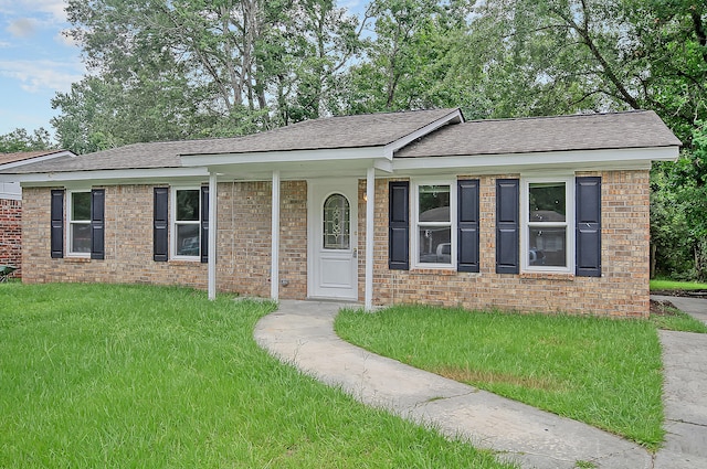 ranch-style house with brick siding and a front lawn