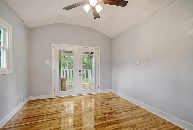 entryway with lofted ceiling, ceiling fan, wood finished floors, baseboards, and french doors