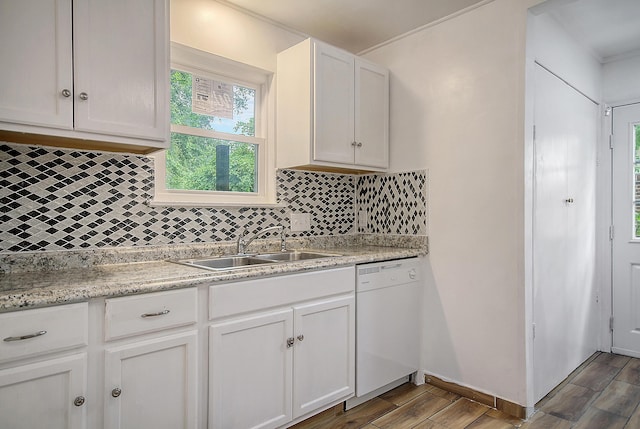 kitchen featuring light countertops, white dishwasher, a sink, and wood finished floors