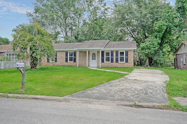 single story home with driveway, brick siding, a front yard, and fence