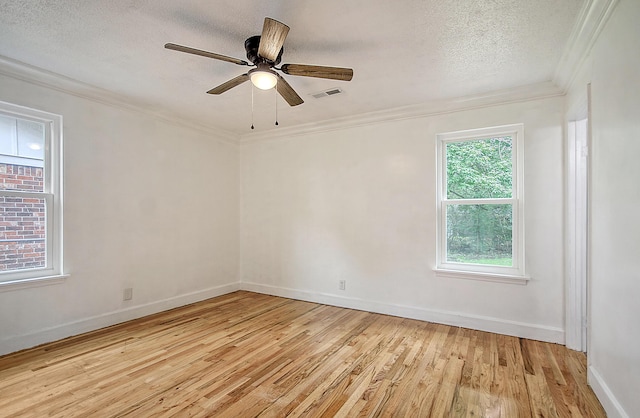 unfurnished room featuring a textured ceiling, ceiling fan, visible vents, light wood-style floors, and crown molding