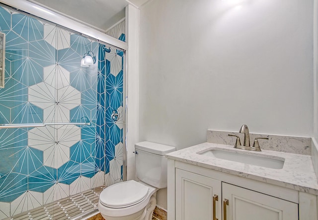 bathroom featuring a stall shower, vanity, and toilet