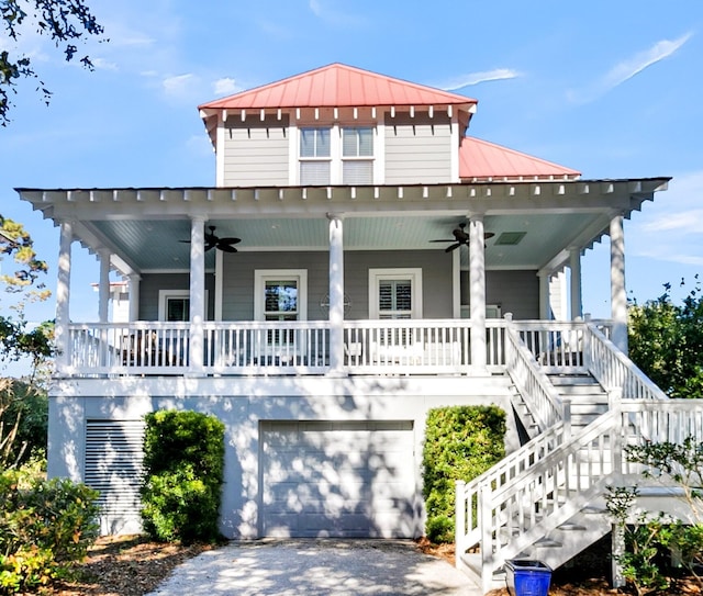 view of front of home with ceiling fan, a garage, and covered porch