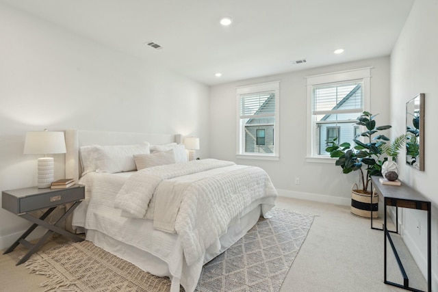 bedroom featuring baseboards, recessed lighting, visible vents, and light colored carpet