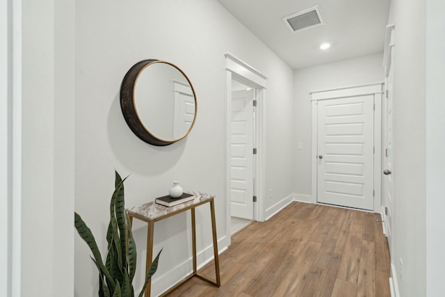 doorway to outside featuring light wood finished floors, baseboards, and visible vents