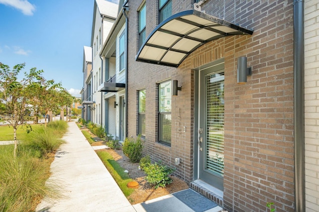 doorway to property with brick siding