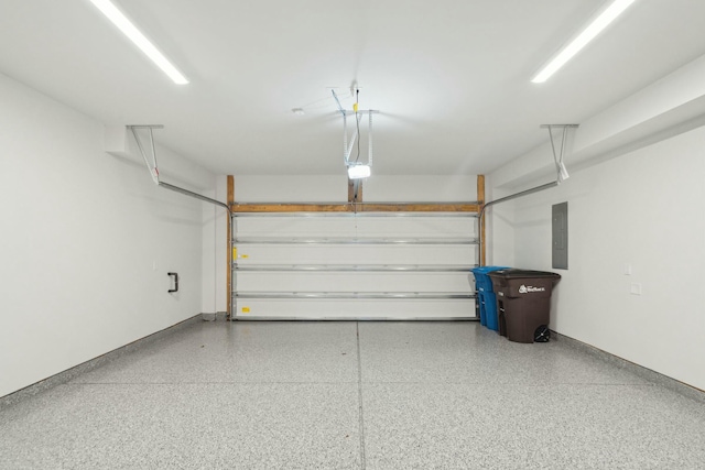 garage with electric panel and a garage door opener