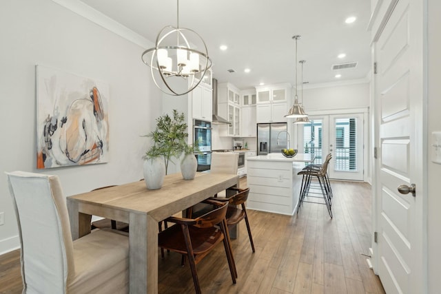 dining space with light wood finished floors, ornamental molding, visible vents, and recessed lighting