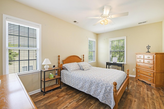 bedroom with ceiling fan, baseboards, wood finished floors, and visible vents