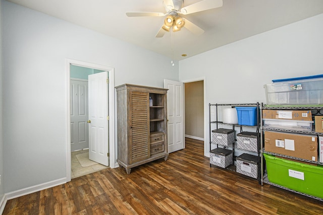 bedroom with ceiling fan, wood finished floors, baseboards, and ensuite bathroom