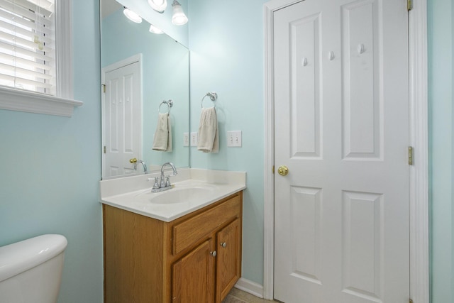 half bath with vanity and toilet