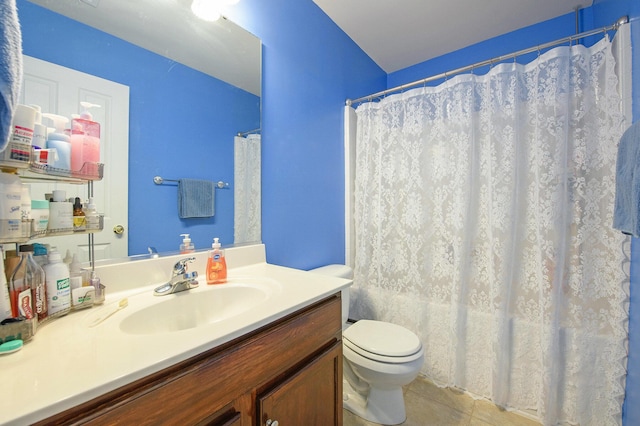 full bathroom featuring tile patterned floors, vanity, a shower with shower curtain, and toilet
