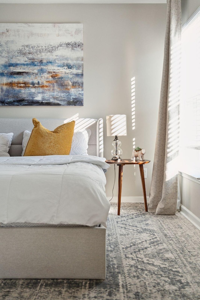 carpeted bedroom featuring baseboards