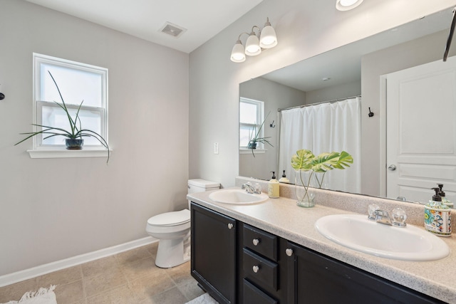 bathroom featuring baseboards, visible vents, a sink, and toilet